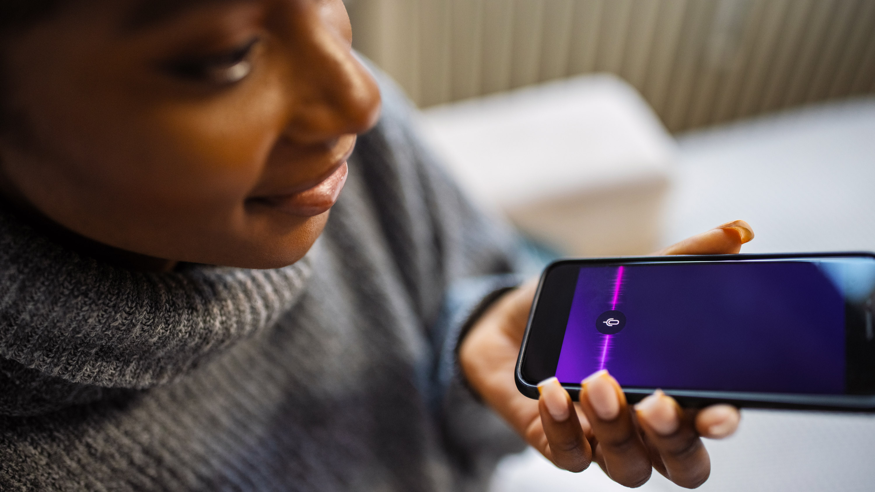 Close-up of young woman talk with virtual digital voice recognition assistant.