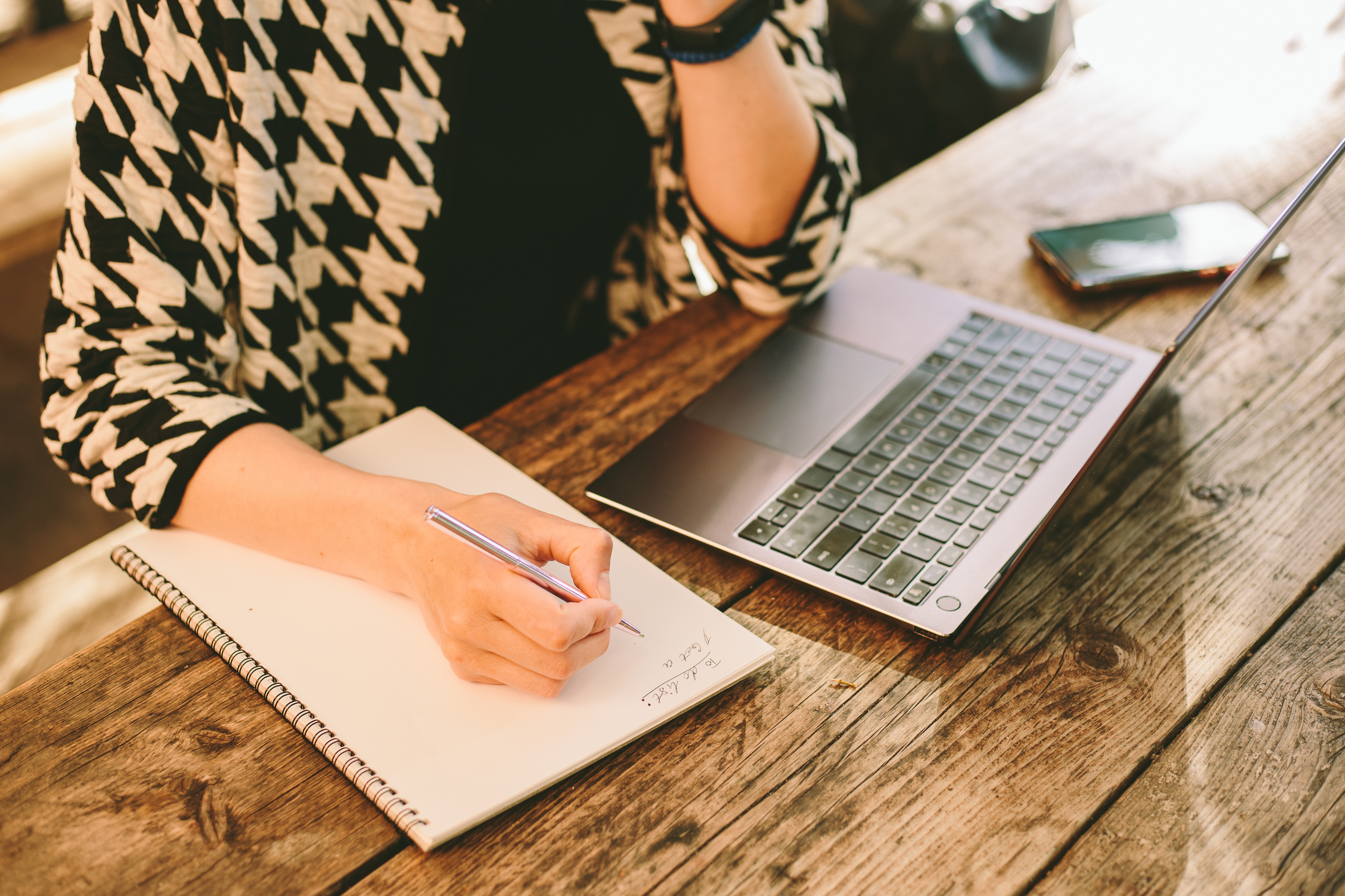 Close up of woman's hand writing a to-do list